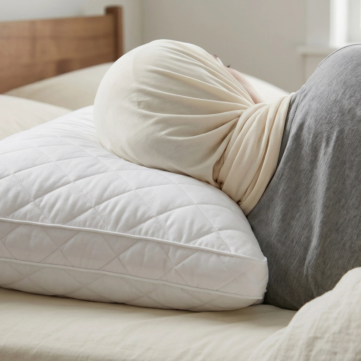 Person resting head on LuxeCotton Quilted Comfort Pillow showing soft support and generous size