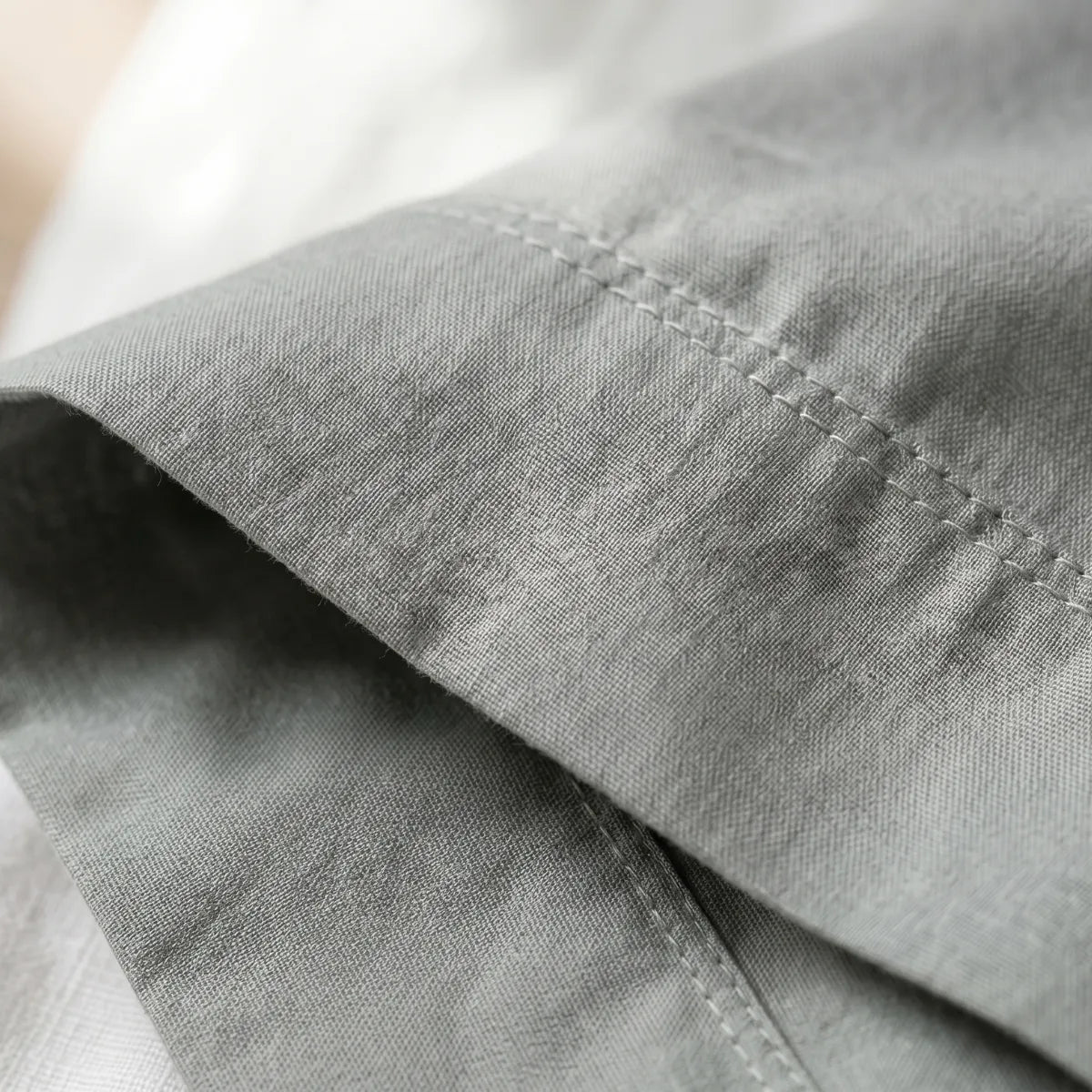 Close-up of Cloud Grey T200 cotton percale fabric weave and hemstitch detail