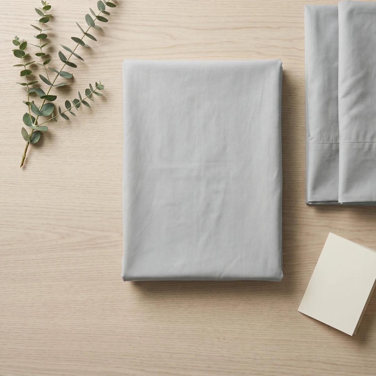 Cloud Grey T200 cotton percale flat bedsheet set folded with eucalyptus by LuxeCotton Pakistan