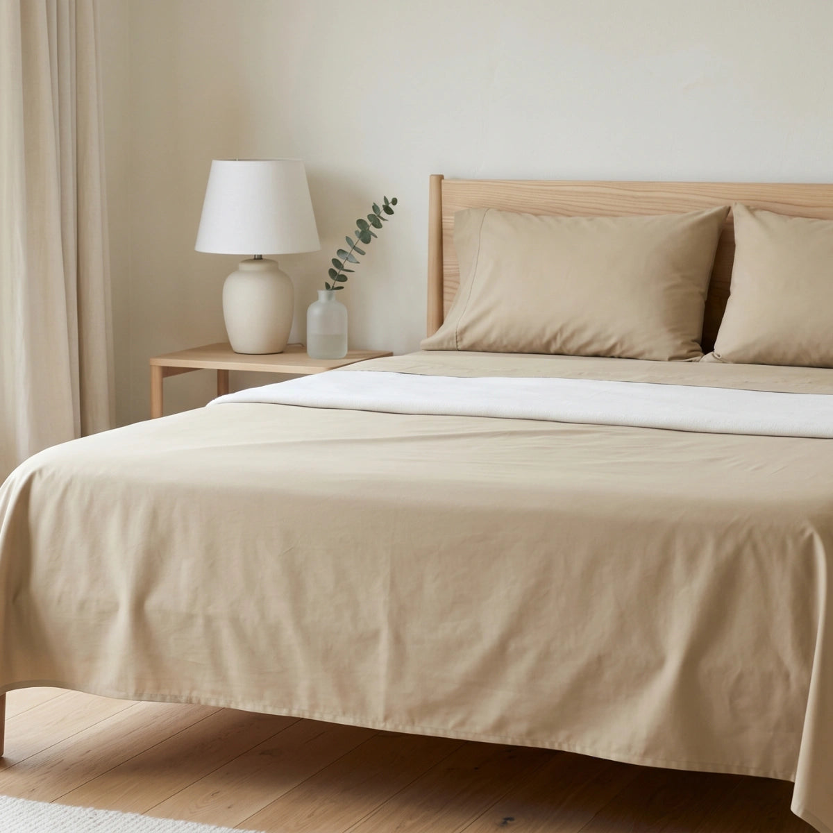 Ivory Sand Beige T200 cotton percale flat bedsheet set on queen bed in warm Scandinavian minimalist bedroom
