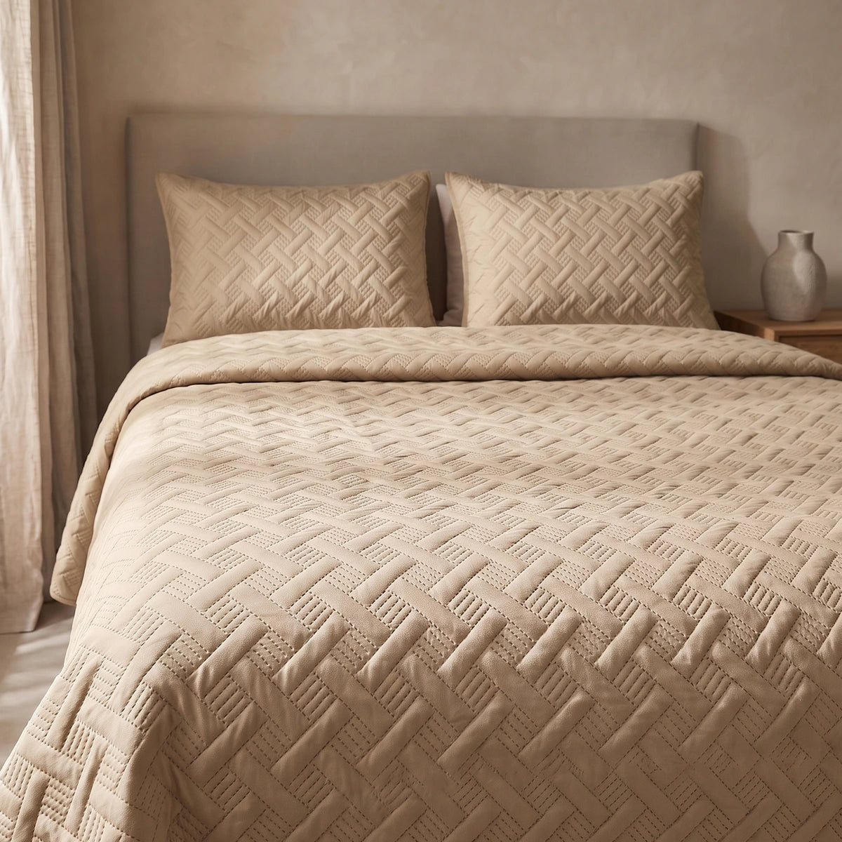 Woven Lattice Quilt bedspread in almond beige styled on a queen bed with matching pillow shams