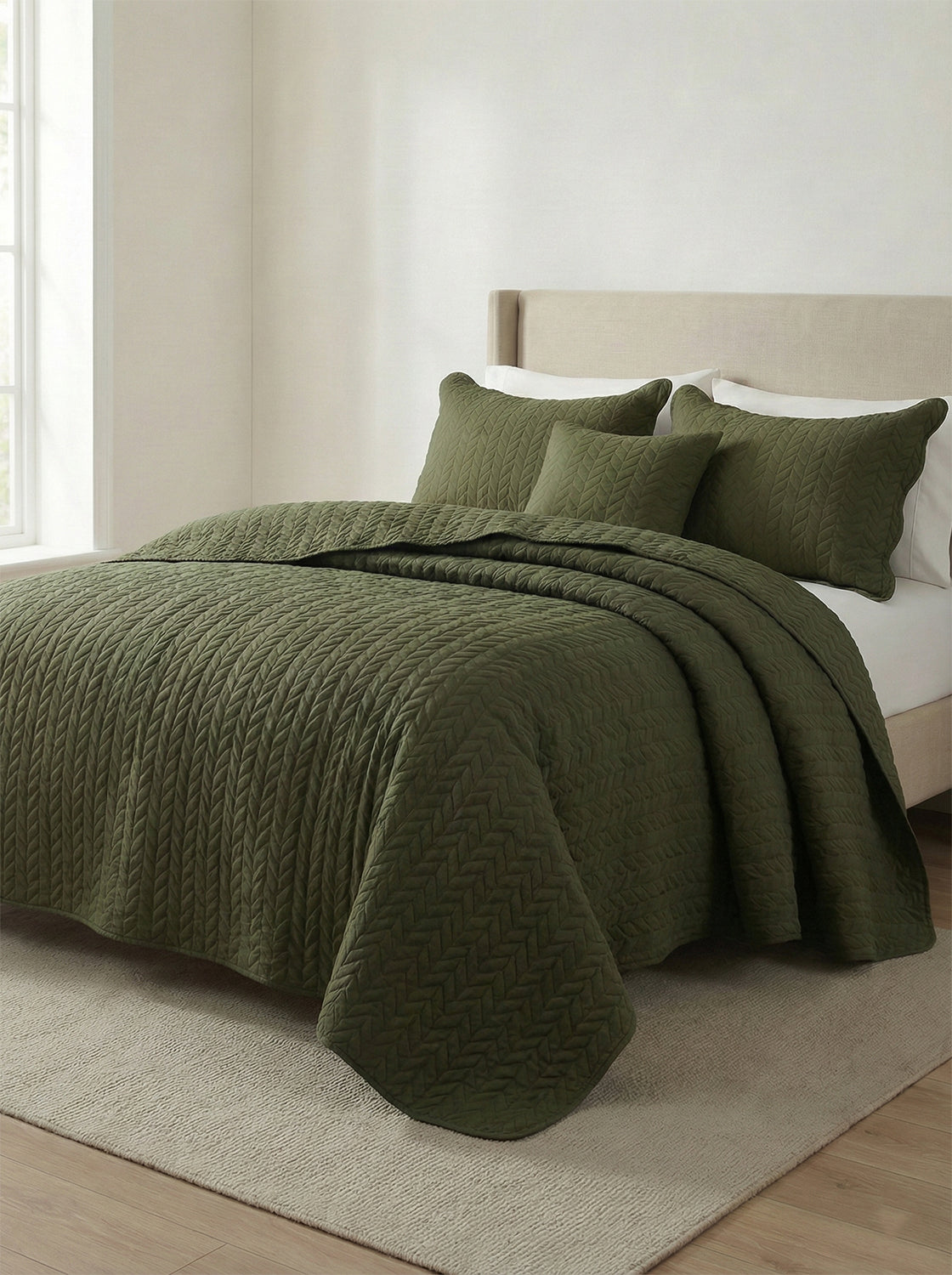 Modern bedroom with olive green quilted bedding set on upholstered bed